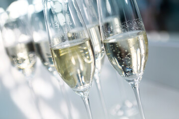 Champagne glasses on white background in bright lights
