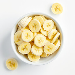 Naklejka na ściany i meble Slices of Bananas in a white bowl on White Background Top Down View Angle