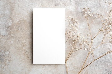 Blank menu card mockup with copy space, trendy white card mock up with gypsophila flowers on beige...