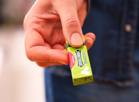 Tambov, Russian Federation - December 20, 2023 A woman giving a pack of Wrigley's Doublemint chewing gum.