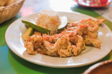 Veracruz-style shrimp, accompanied with white rice, and avocado.