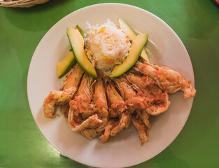 Veracruz-style shrimp, accompanied with white rice, and avocado.