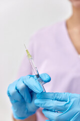 Woman holding medical injection syringe in her hand