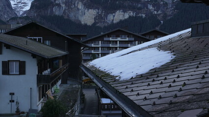 Traditional Swiss houses in the Alps during winter season - Switzerland chalet roof with some snow