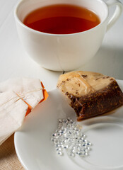 Tea bags and plastic pellets on a bowl