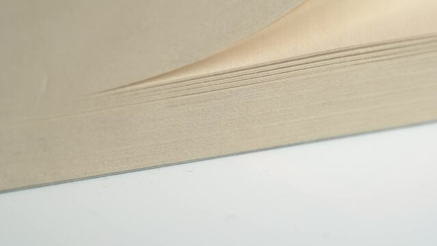 Flipping pages of a book, close-up, macro shot.