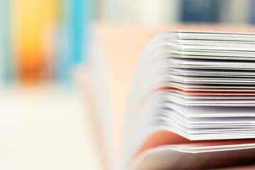 Macro view of open book pages with blurred color background