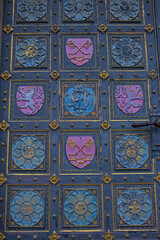 Fragment of the door to the neo-Gothic Cathedral of Saints Peter and Paul in the Visegrad Fortress in Prague. Coat of arms on the church door. This stunning church is the centerpiece of Visegrad.