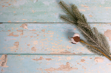 Cotton and pine branch winter decoration on vintage wooden background. Top view. - 715844479
