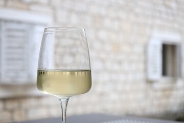 Glass of wine outdoors, closeup. Space for text
