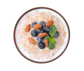 Tasty wheat porridge with milk, blueberries and almonds in bowl isolated on white, top view