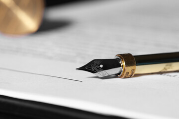 Fountain pen and paper document on table, closeup with space for text. Notary service