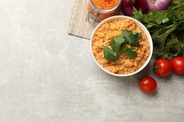 Delicious red lentils and products on light grey table, top view. Space for text