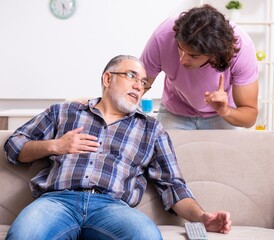 Young student and his old grandpa at home