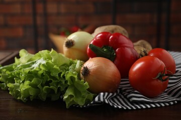 Different fresh vegetables on wooden table indoors