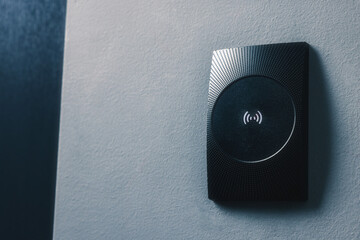 Magnetic door lock on grey textured wall, space for text. Home security