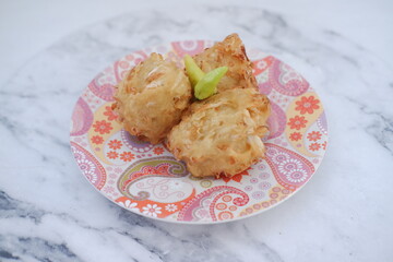 Bakwan sayur or vegetable fritter, Indonesian snack made from flour, cabbage, carrots and bean sprouts, served with chili