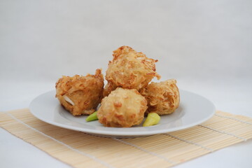 Bakwan sayur or vegetable fritter, Indonesian snack made from flour, cabbage, carrots and bean sprouts, served with chili