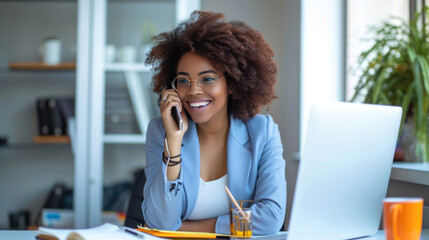 Obraz premium Young woman is focused on working on her laptop in a modern office