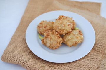 Bakwan sayur or vegetable fritter, Indonesian snack made from flour, cabbage, carrots and bean sprouts, served with chili