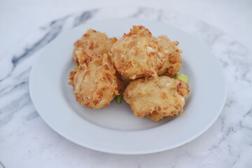 Bakwan sayur or vegetable fritter, Indonesian snack made from flour, cabbage, carrots and bean sprouts, served with chili