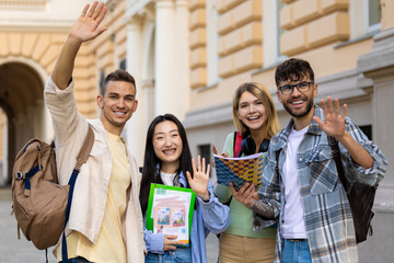 College multiethnic students standing in campus with books and backpacks.