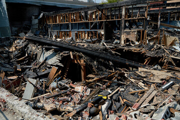 A burnt-out old wooden building after a fire. Charred beams after the destruction.