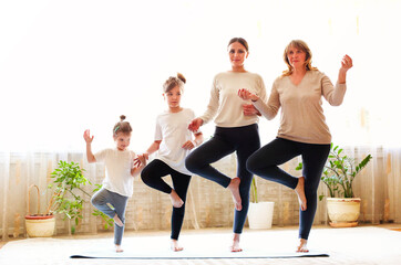 Naklejka premium Multi generational family doing yoga together