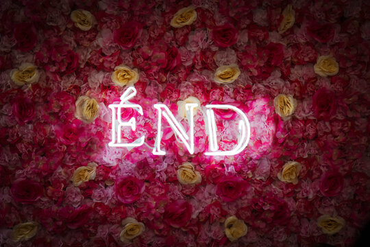 the word end glowing on a background of flowers