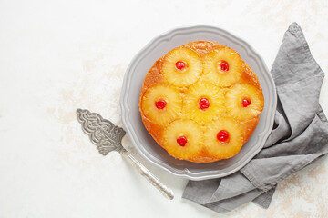 Homemade pineapple upside down pie with candied cherries . Tropical dessert on white background....