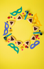 Hamantaschen Cookies for Purim Celebration on Yellow Background