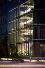 Kalnciema street in Riga, Latvia during twilight. Night photography, street photography with long exposure. Beautiful public building with night during night time with traffic in the foreground