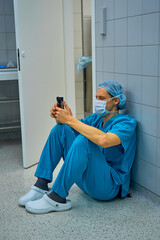 plastic surgeon is sitting on the floor in the operating room