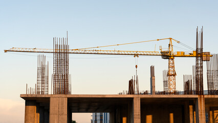 tower cranes at construction site and city background