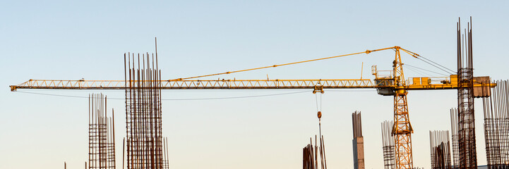 tower cranes at construction site and city background
