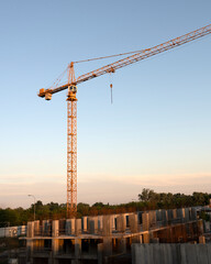 tower cranes at construction site and city background