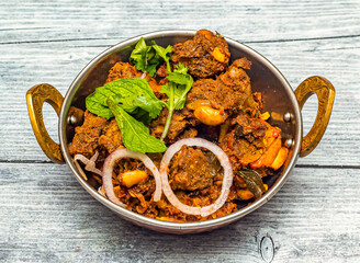 mysore mutton sukka bhuna karahi served in dish isolated on wooden table top view of indian spicy...