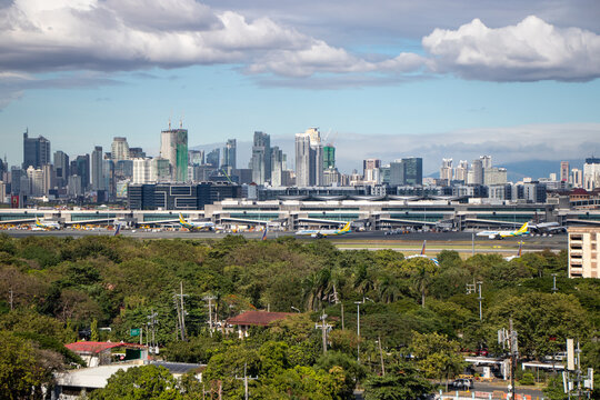 Aerial view of Terminal 3 at Ninoy Aquino International Airport, with the Manila skyline in the background - Manila, Philippines