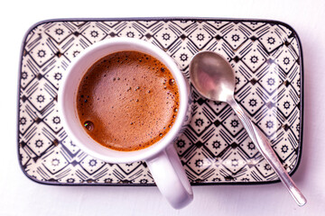 White cup with black coffee on a rectangular plate on the table - 715905020