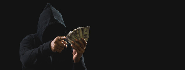 Portrait killer hacker mafia gangster spy man oneperson in black hoodie standing look hand holding...