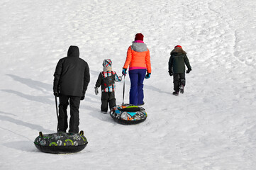 Family, winter leisure, snow tubes