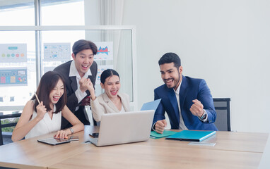 Portrait business team woman and man Asian group meeting sitting on desk looking computer hand holding laptop notebook ready for idea new project happy working online sale inside the home office