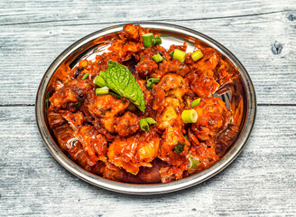 gobi manchurian served in dish isolated on wooden table top view of indian spicy food