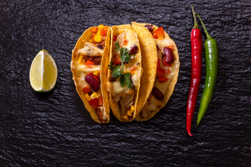 three mexican tacos on slate