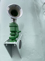 Starboard ship’s horn on the wall. Green ship alarm. Marine equipment.