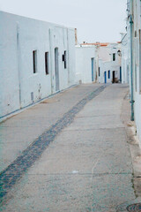 Lone street of an Andalusian town whitewashed with no inhabitants and no sign of life