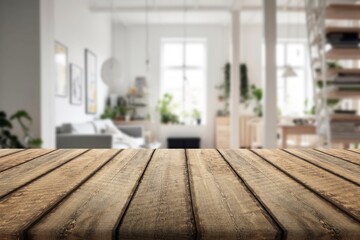 Wooden table top at the blurred background interior.