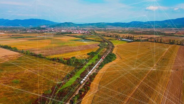 Aerial view cargo train freight transportation by rail and logistics and technology transportation concept with holographic lines connecting augmented reality