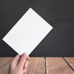 Man hand holding a invitation card isolated.