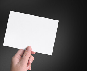 Man hand holding a invitation card isolated.